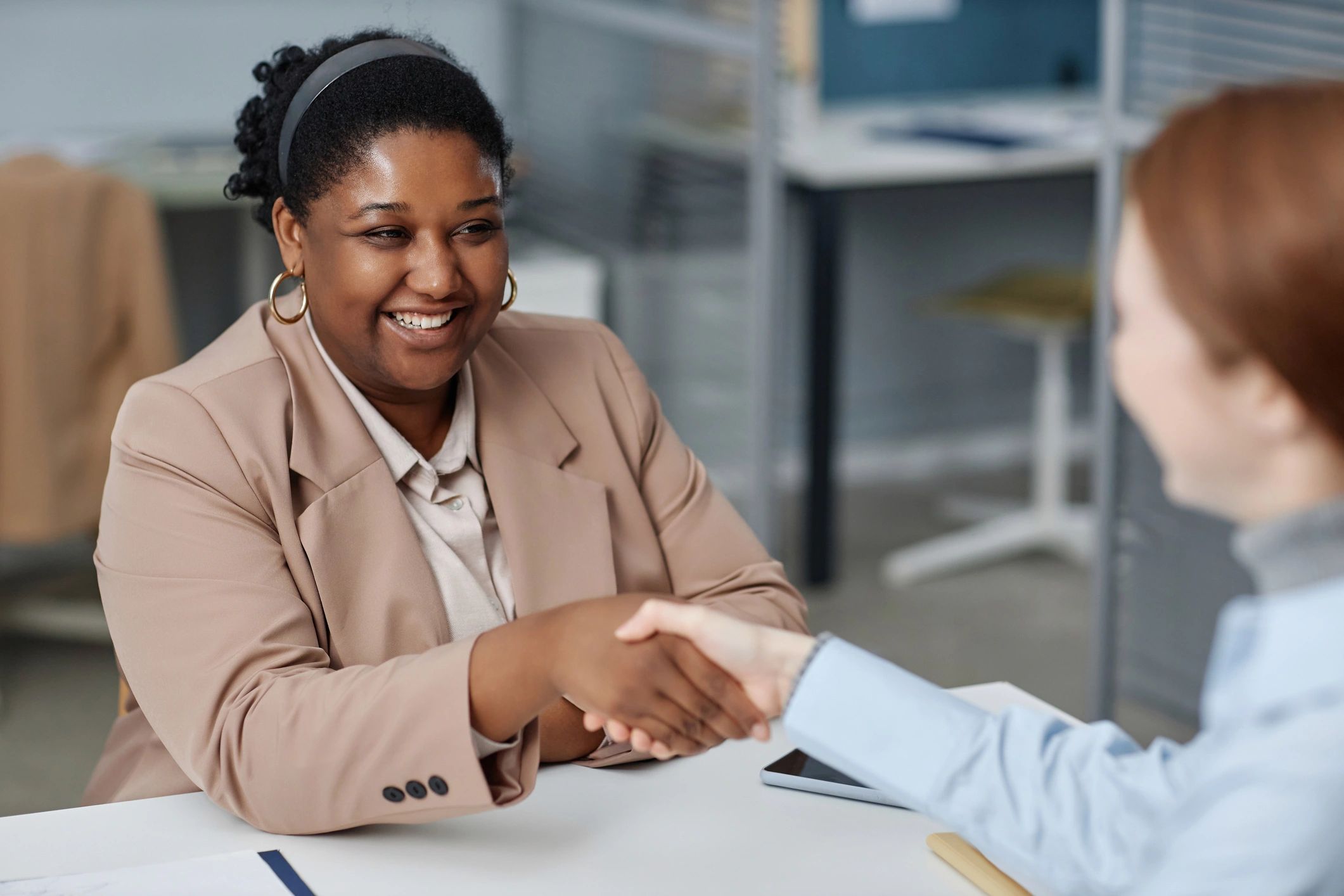 Recruiter greeting a job candidate during an interview